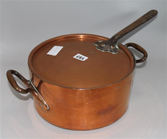 A copper two handled pan with lid